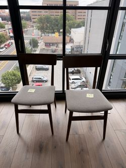 Two brown dining chairs