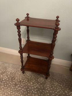 Solid wood 3-tier display shelf in good condition.