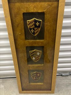 Framed medieval shields.. ready to hang by John Richard. 16” x 39” $50