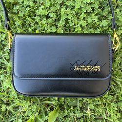 Black leather crossbody/shoulder/clutch bag with gold hardware. 
