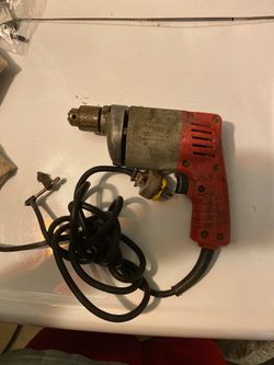 Milwaukee corded 1/4” drill with reverse and chuck key