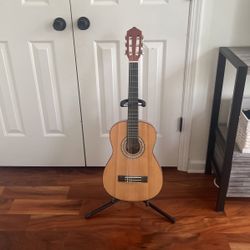 small acoustic guitar with stand