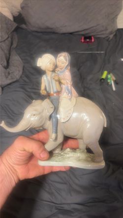 Porcelain Figurine Two Children Riding Elephant