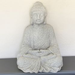 Large sandstone buddha statue with candle