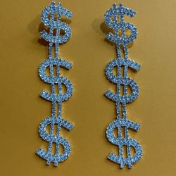 Silver tone rhinestone bedazzled dangling dollar sign earrings.