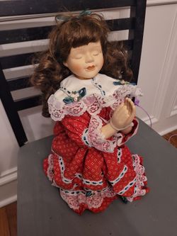 Praying porcelain doll