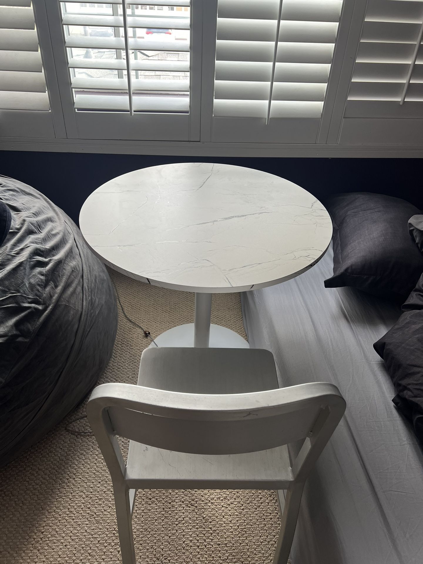 White marble table with a chair