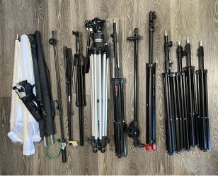 Camera equipment tripods and photo lighting umbrellas.