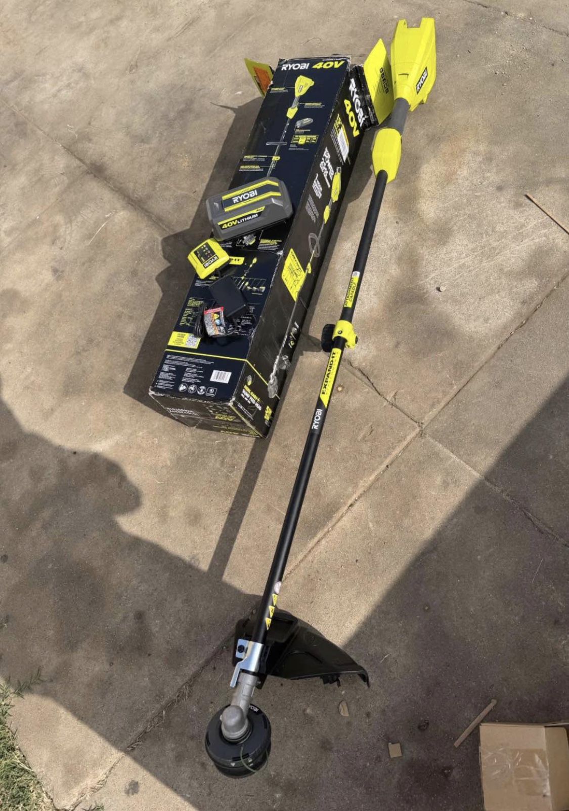 RYOBI 40V 15 in. Expand-It Cordless Battery Attachment Capable String Trimmer with 4.0 Ah Battery an