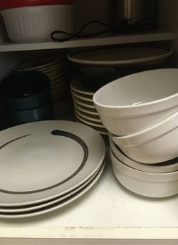 Cabinet full of dishes plates bowls there’s more than pictured