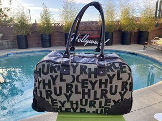 AWESOME HURLEY DUFFLE BAG/ROLL AWAY CARRY ON, WITH HIDDEN TELESCOPING HANDLE. 