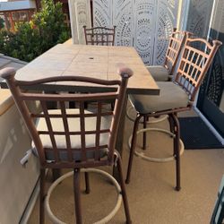 Outdoor Patio Bar Table + 4 Swivel Chairs  Nice outdoor bar-height patio set with 4 swivel chairs.