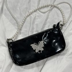 Black patent hobo bag with rhinestone butterfly and pearl chains