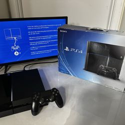 PlayStation 4 console with controller and box