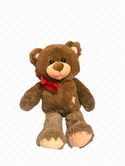 Brown teddy bear with red bow