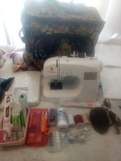 A Singer sewing machine 34dn model 4166 including fabric material thread needles and other accessories working