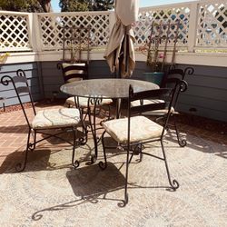 Vintage glass top wrought iron table and chairs