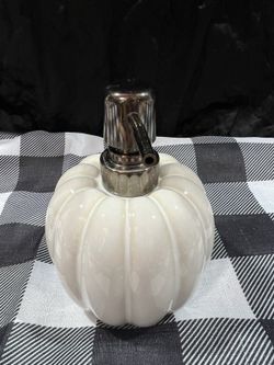 white ceramic pumpkin-shaped soap dispenser