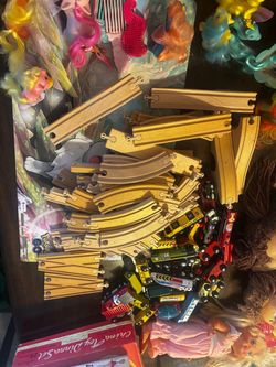 Wooden train, tricks and sorted toy vehicles have a bunch