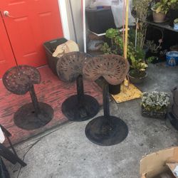  Three tractor seat stools yard art