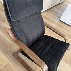 Wooden framed rocking chair with black cushion