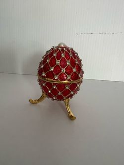 Fabergé style egg, red enamel, a gold-plated lattice design. crystal embellishment’s.