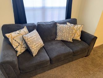 Grey couch with pillows