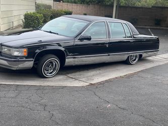 1996 triple black Cadillac fleetwood
