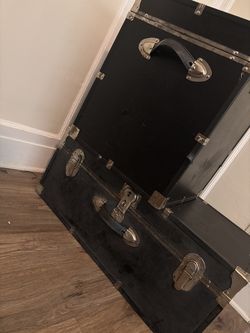Two black antique trunks