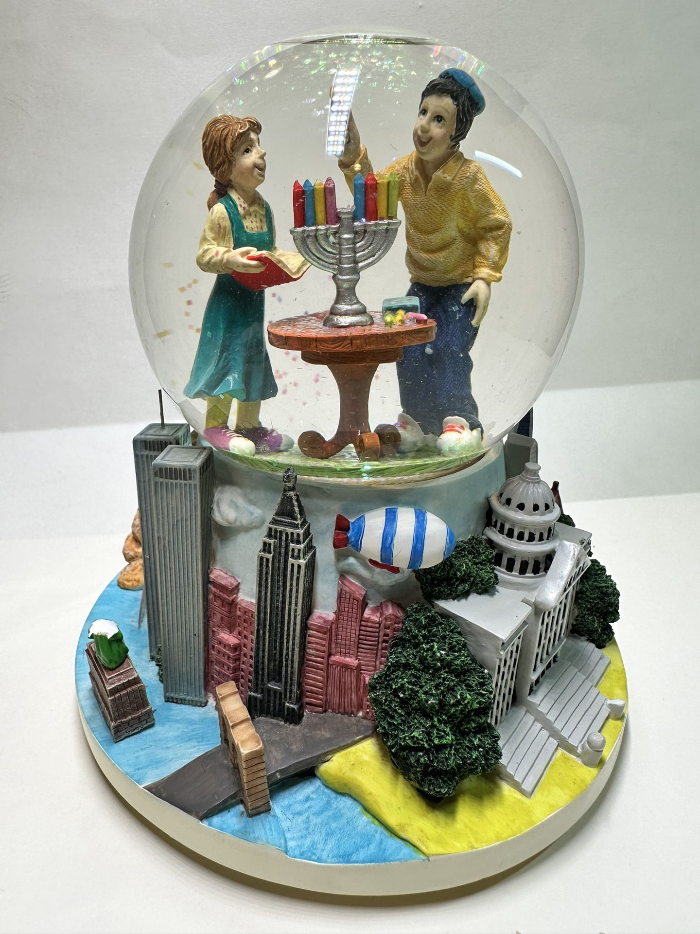 snow globe featuring two figures lighting a menorah,USA Landmarks