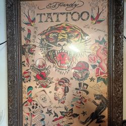 This is a framed Ed Hardy tattoo collage poster.