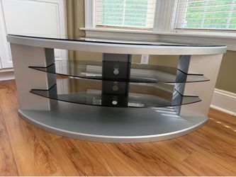 Sleek metal tv stand with glass shelves