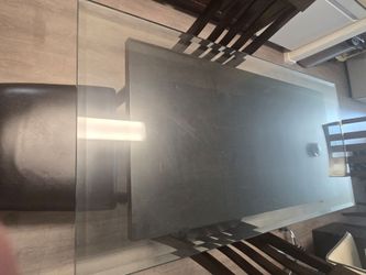 Urgent! Moving and need to them gone.Modern dining set features a dark wood frame with a rectangular glass tabletop and chairs upholstere.