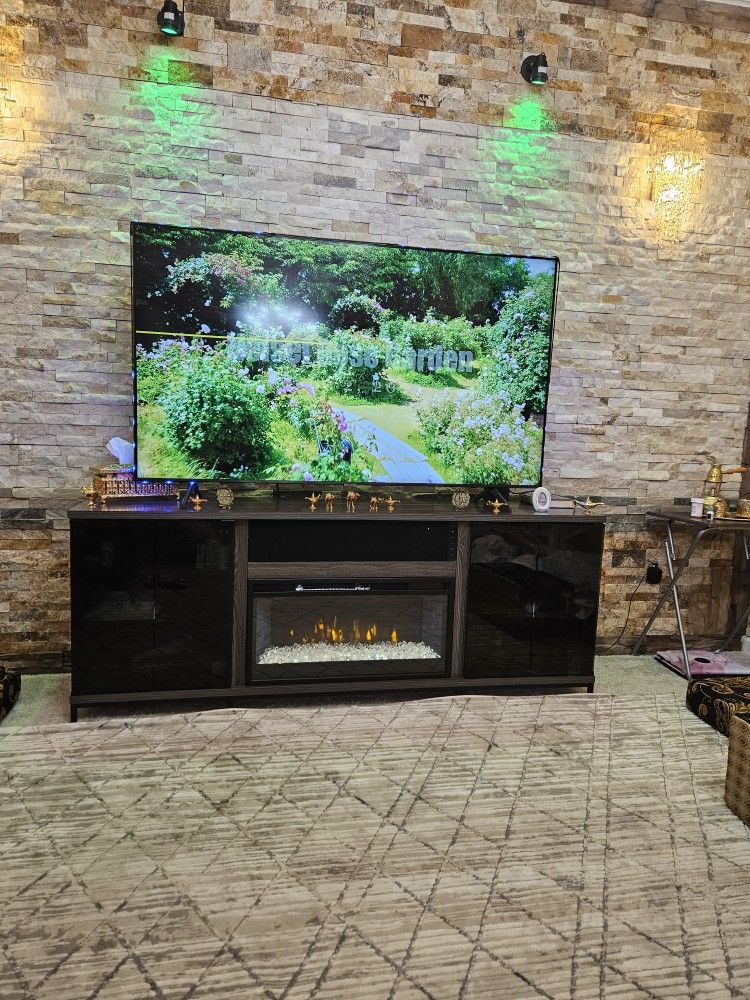 Large TV stand with fireplace and Bluetooth speakers