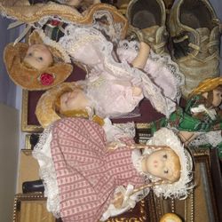 A Small Box Of Mini Porcelain Dolls And Frames Etc
