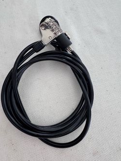 This is a 4-digit combination cable lock designed to secure laptops and notebooks.The cable is typically 6 feet long and features a vinyl-coated steel