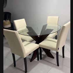 🪑🍽️ Modern Dining SetRound glass-top table with solid wood base. Includes 4 genuine leather chairs