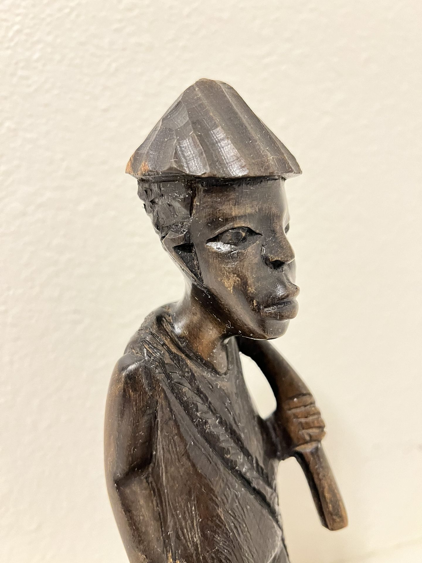 A statue of an African earth worker made of dark wood. Vintage statue Home decor