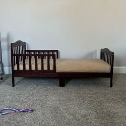Brown toddler bed with Graco mattress and sheets included