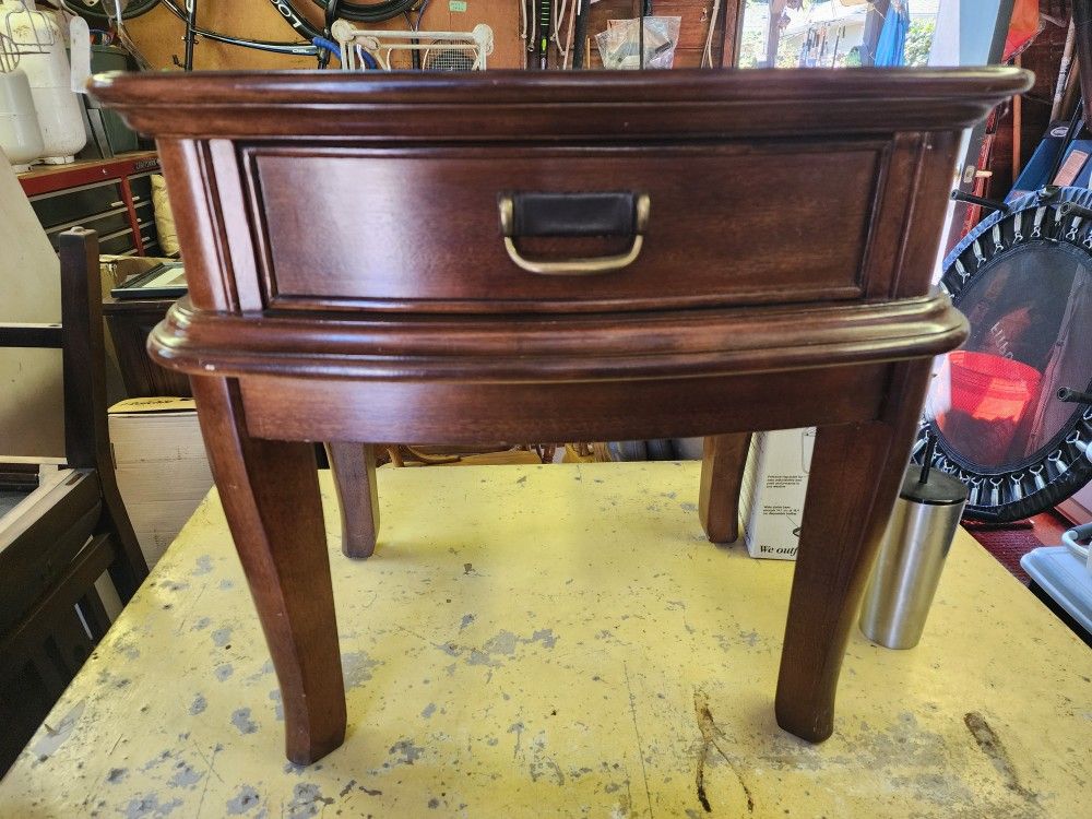 Dark Wood End Table with a dark brown weathered look. Drawer with brass and leather pull.