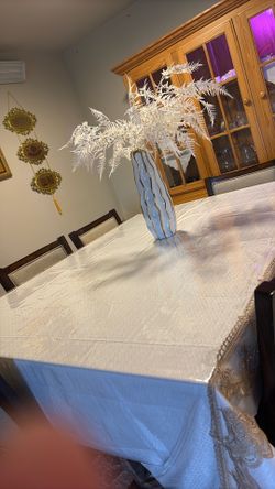 A very good quality wooden table with eight chairs.