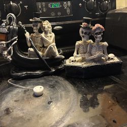 2 Couple Skelly Statues One Lights Up