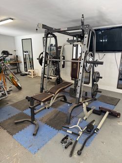 Smith machine/squat rack, cable crossover on top, low row and pec fly.