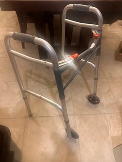 Walker.  Has two wheels in front. Folds