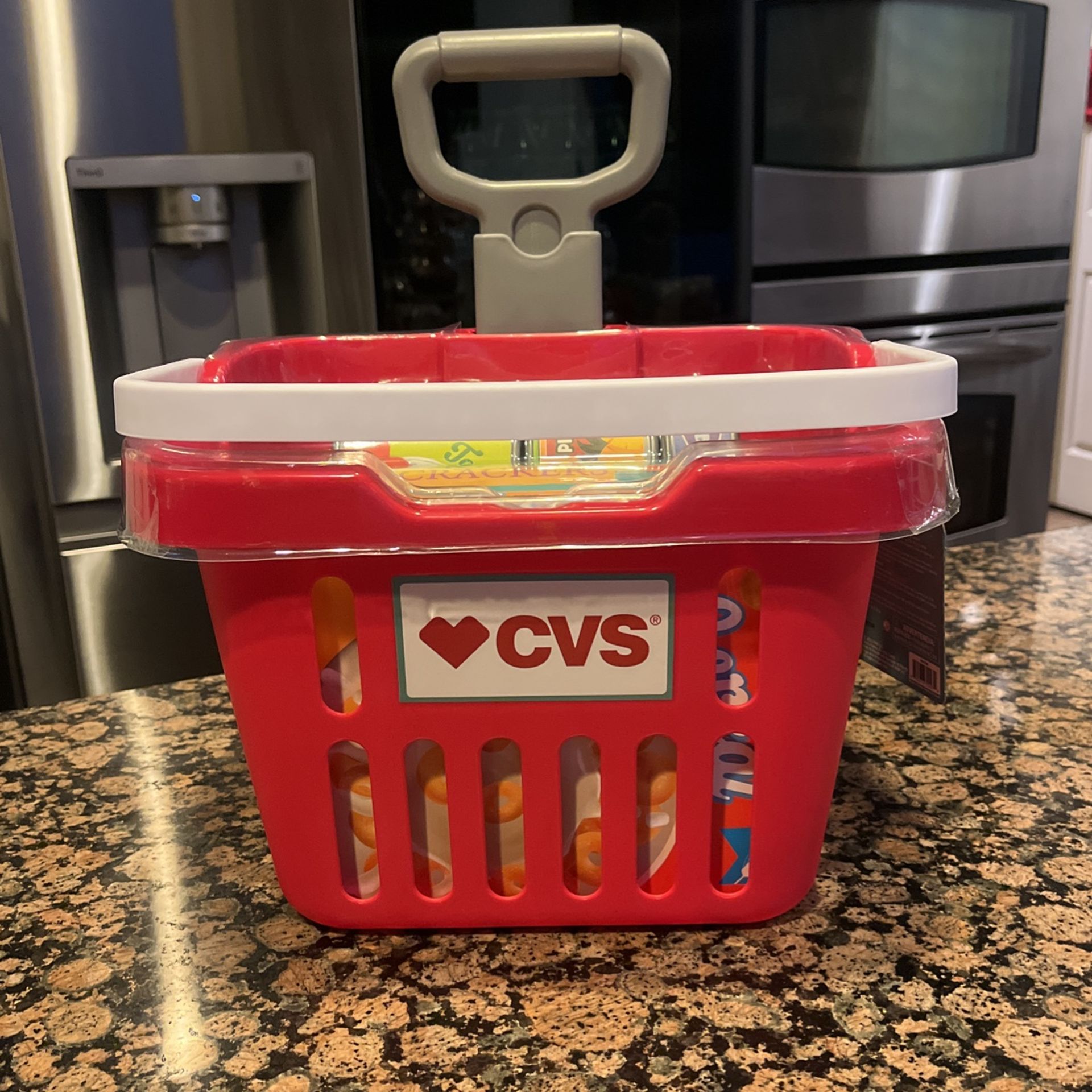 CVS toy shopping cart with wheels and faux food items