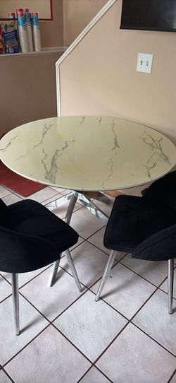 Round marble table set with chairs