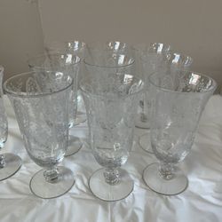 A set of clear vintage etched glass goblets with floral patterns perfect crystal