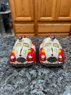 Ceramic Henry Cavanagh Fire Chief Car Salt and Pepper Shaker Set .  Size Approximately 2 inches tall, 3 1/4 inches long and 2 inches wide.  Brand new
