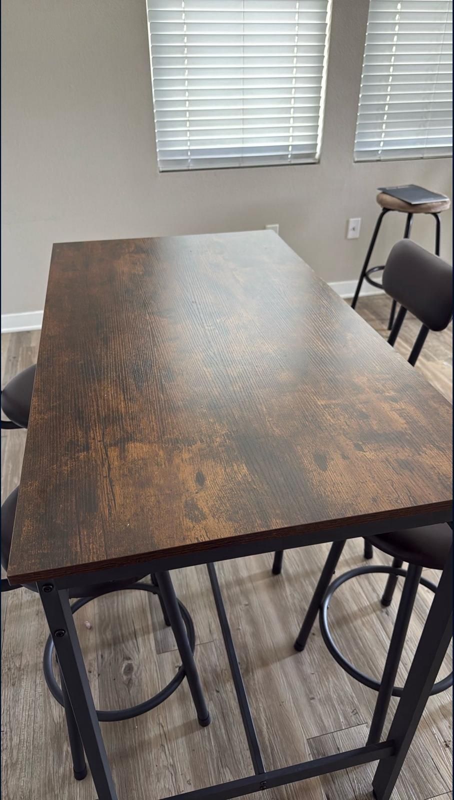 Brown and Black Dinner Table With Stools