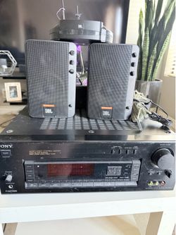 vintage audio setup consisting of a Sony STR-D965 Audio/Video Control Center receiver and a pair of JBL Control 2.4G wireless speakers